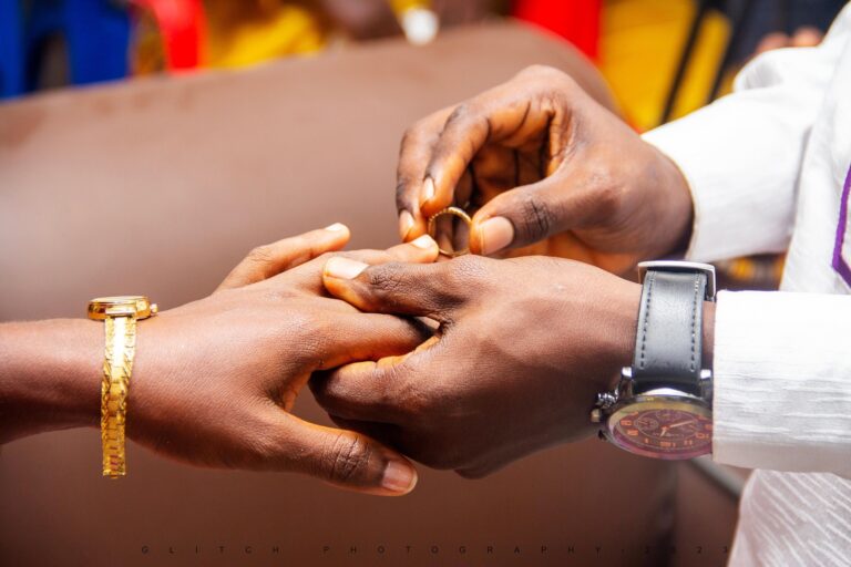 Two people exchanging engagement rings