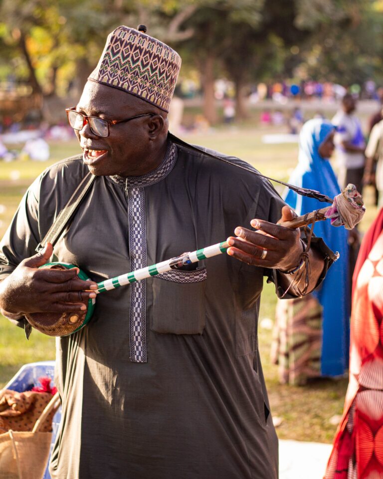 Traditional African musician performing outdoors, photo by Minibell Abdoul on Pexels