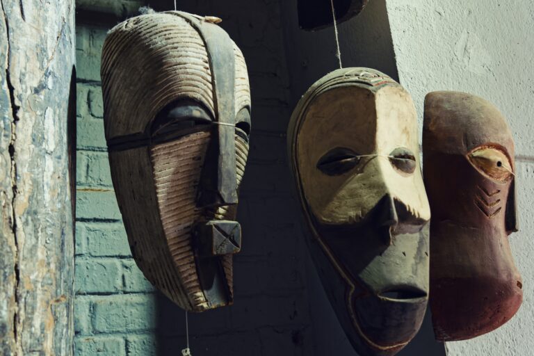 Traditional African masks on display in a gallery, photo by Eric Prouzet on Pexels