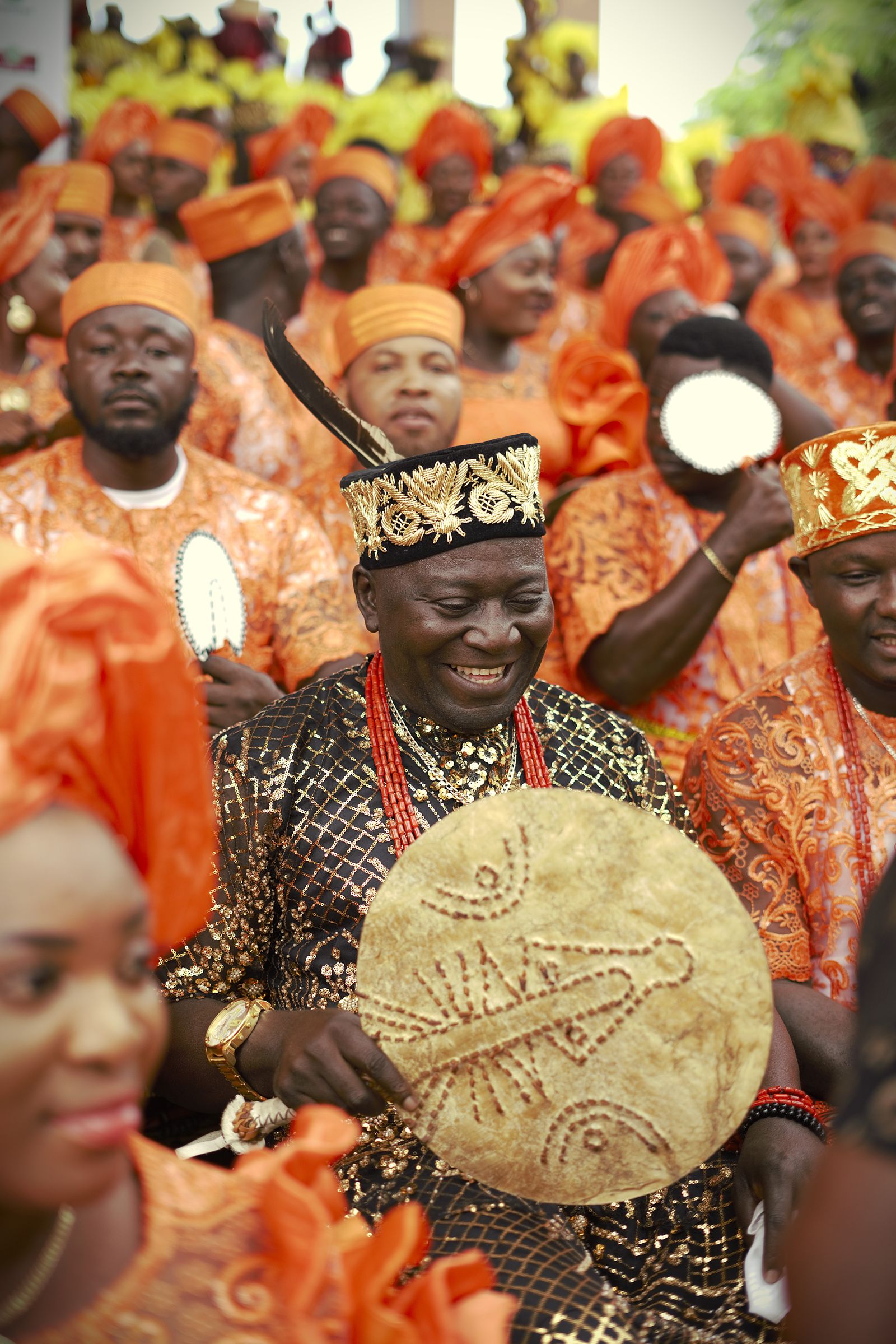 Group of adults in traditional attire celebrating outdoors in Onitsha, Nigeria